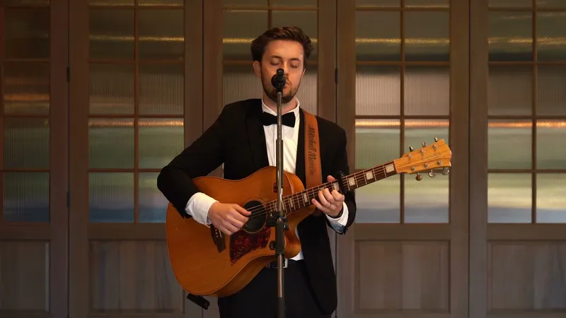 Mitchell Martin singing and playing guitar at a Perth wedding ceremony